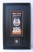 Photo of a commemorative Harley Davidson pin and ticket with a US 
background.